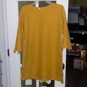 Golden yellow tunic dress with ties for the sleeves to be rolled up.